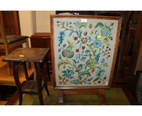 AN OAK FRAMED TAPESTRY FIRE SCREEN TOGETHER WITH A SMALL OAK TWO TIER TABLE 