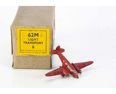 A Dinky Toys 62m Light Transport Plane Trade Box, containing one example in red, 'G-ATMH' markings, two, two blade props, F-G