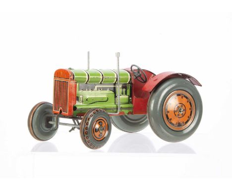 A Mettoy tinplate clockwork Tractor, in green and red with orange and grey wheels, working steering and clicking starter hand