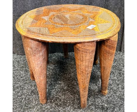 Tribal style carved stool raised on eight legs [36.5x43x45cm]