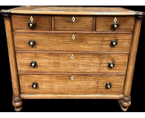 19th century chest, the shaped top above three short drawers and three long graduating drawers flanked by turned column suppo