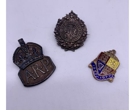 Two sterling silver badges and silver pendant; Argyll and Sutherland Highlanders Regiment silver uniform badge, Silver ARP ba