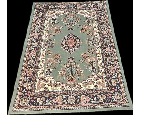 A green ground antique style rug