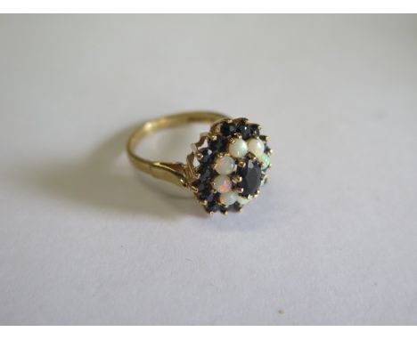 A hallmarked 9ct yellow gold opal and sapphire cluster ring, head 15mm wide, ring size O, approx 3.7 grams in good condition 