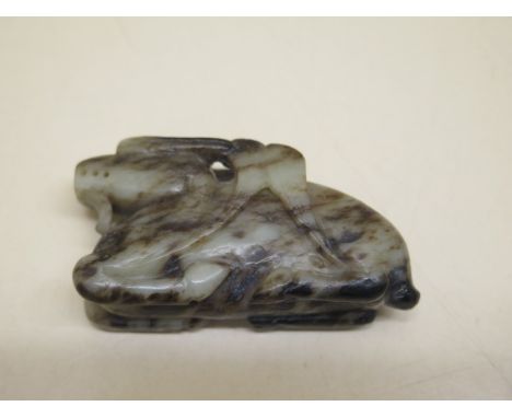 A mottled jade carved dragon, 7cm x 3.5cm, in good condition 