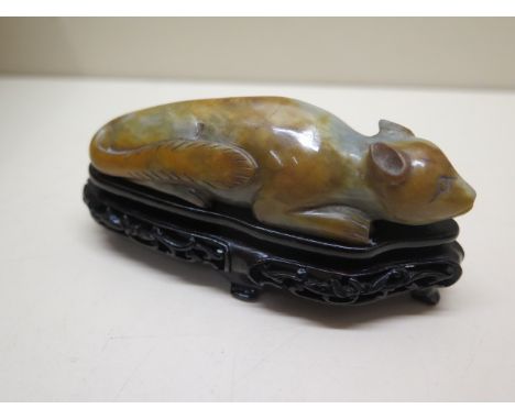 A carved jade celadon and russet tree squirrel on a carved base, 5cm tall x 10cm x 4cm wide, in good condition 