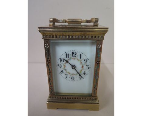 An 8 day French carriage clock strikes hours / half hours, the case decorated with inlaid ceramic flowers, 13cm tall x 8cm wi