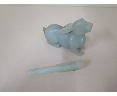 A carved jade rabbit, 10cm long and a cigarette holder, 9cm long, both generally good with no obvious damage 