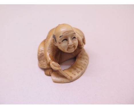 A well carved 19th / early 20th century ivory scribe Netsuke, 3cm x 4.5cm, in good condition 