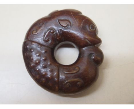 A carved jade celadon and russet fish roundal, 4.5cm x 1.5cm, in good condition 