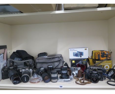 A collection of four SLR cameras with assorted lenses: Minolta X-700, Nikon F55, Canon T70, Minolta 7000, a Kodak Retinette I