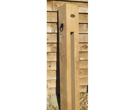 A new green oak bicycle lock post, 149cm tall x 19cm x 19cm with plaque and ring plate 