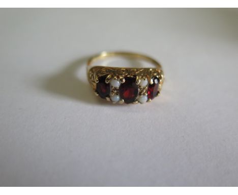 A hallmarked 9ct yellow gold garnet and opal ring, size O, approx 3.4 grams in good condition 