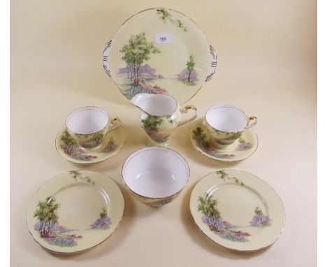 An Aynsley tea service comprising eleven cups and saucers, twelve tea plates, two cake plates, sugar and milk jug with bluebe