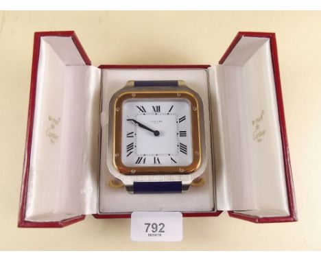 A Cartier travel alarm clock in original box  Serial no. 7508 09890