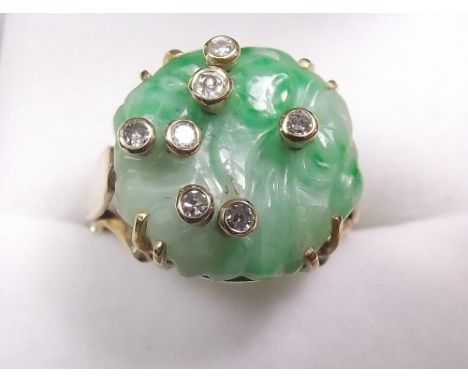 A 9 carat gold carved jade ring with scattered collet set diamonds - size N and a half