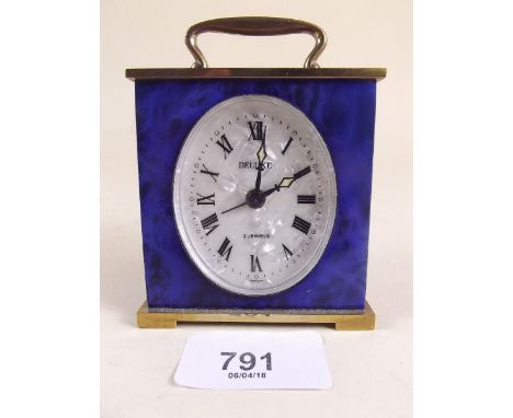 A small blue and gilt metal brass alarm clock