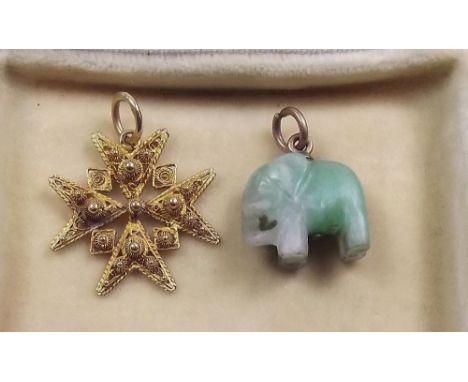 An Indian high grade gold filigree star form pendant and a jade miniature elephant