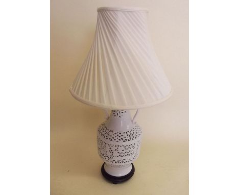 A white reticulated table lamp and cream shade - 38cm