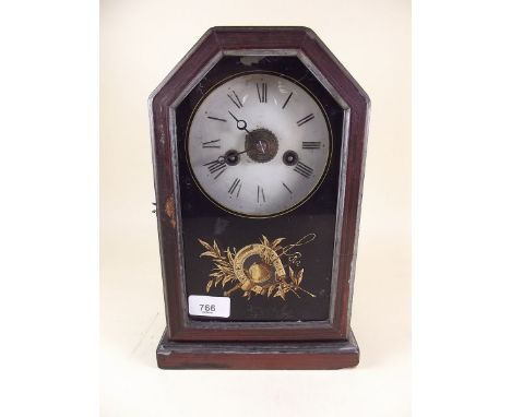 An American shelf clock with jockey hat and whip decoration painted to door