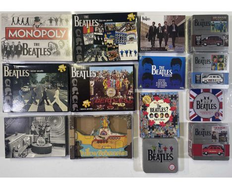 A collection of items relating to The Beatles includes six jigsaw puzzles, a sealed box of Monopoly, three die-cast model car