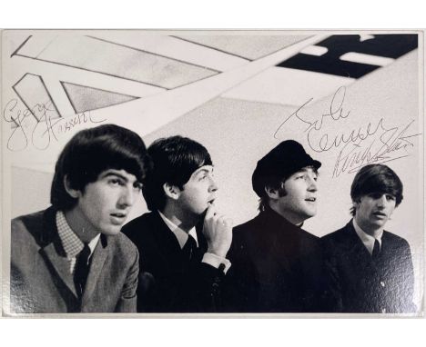 An approx 26.5 X 18 cm fully signed Beatles photograph. The photograph is signed by George Harrison, John Lennon, Ringo Starr