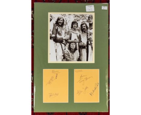 Monty Python signed by 5 ( not graham ) Black and White photograph mounted with two pieces of paper signed . Monty Python (al