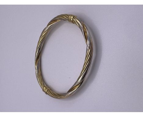 A 9ct two colour gold bangle, approximately 7g