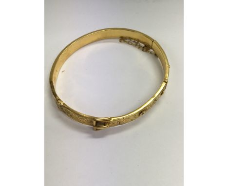 A 9 ct gold buckle bangle 9 grams .