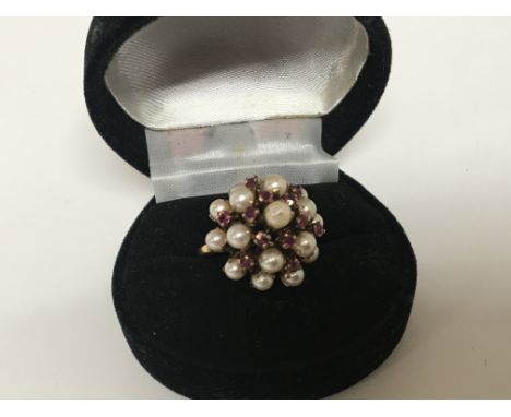 An 18carat gold cocktail type ring set with a cluster of pearls and ruby weight 5.5g ring size N-O