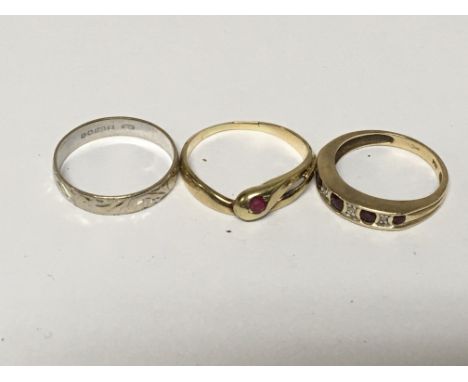 Two gold rings set with ruby and diamonds and one other 18carat white gold wedding ring (3)