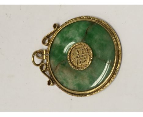 A Chinese jade pendant inset in an unmarked gold mount .