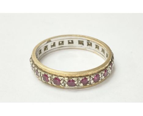 A 9ct gold and silver ring set with rubies and diamonds. The approximate ring size is k.