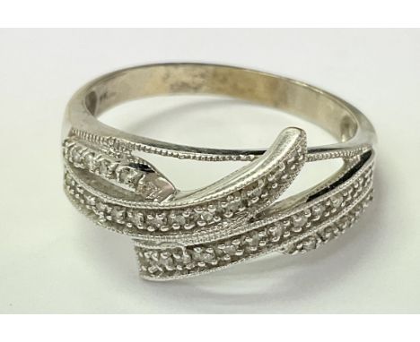 A 9ct white gold ring set with small diamonds. The approximate ring size is between x and y.