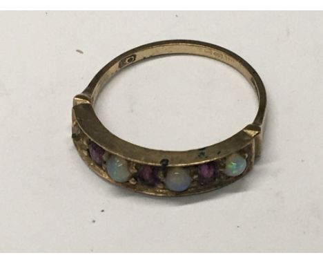 A 9carat gold ring set with opals and alternating Ruby weight 2g one stone missing - NO RESERVE