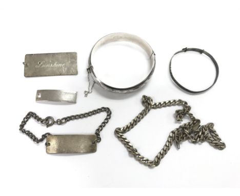 A collection of silver jewellery items comprising bangle, curb chain and other items.