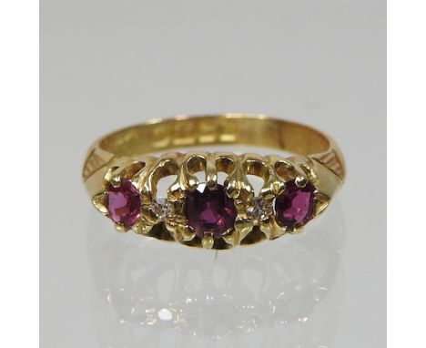 An 18 carat gold ruby and diamond five stone ring