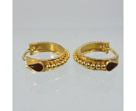 A pair of unmarked ladies hoop earrings, with enamel decoration