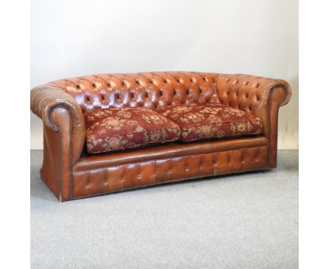 A vintage brown leather button upholstered Chesterfield sofa, 204cm