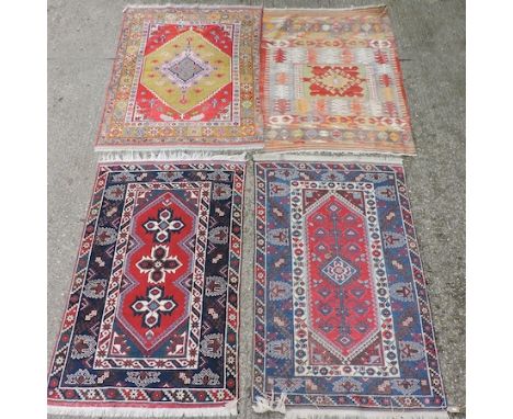 A Persian rug, with a central medallion, on a red field, 190 x 120cm, together with another similar, another on a green field