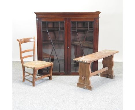 A glazed mahogany bookcase, together with a rush seated child's chair and a Chippendale style child's chair