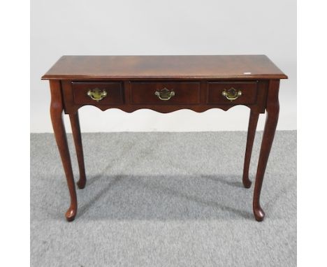 A cherrywood three drawer side table, 92cm