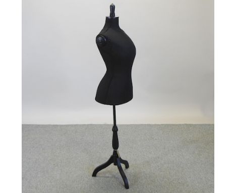 A black fabric mannequin, on a tripod stand