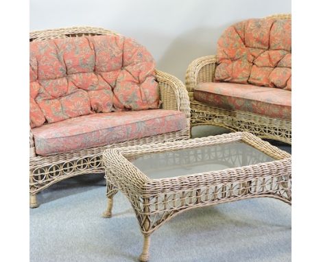 A wicker conservatory suite, comprising a sofa, 130cm, another smaller and a coffee table