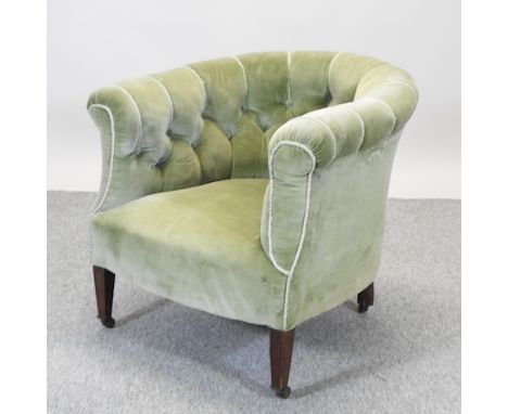 An Edwardian green upholstered button back armchair