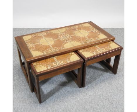 A 1970's nest of three tile top occasional tables, 96cm