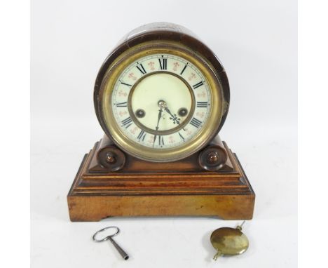 An Edwardian walnut mantle clock, with a white enamel dial, 28cm high