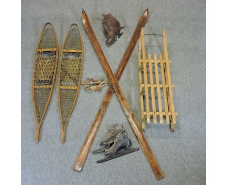 A pair of Canadian vintage wooden snow shoes, bearing a label for Strand, 146cm, together with a pair of wooden skis, a woode