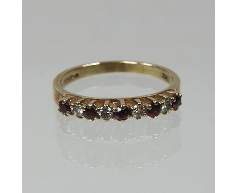 A 9 carat gold ruby and diamond half hoop eternity ring