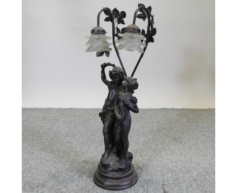 A bronzed figural table lamp, with glass shades, 75cm high